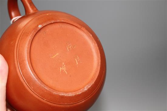 A Chinese Yixing teapot and cover, a redware teapot and cover and a cup